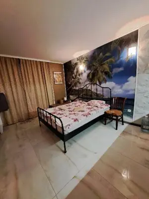 a bedroom with a bed and a painting on the wall at Apartment with sea view in Sunny Beach