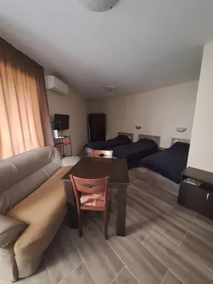 a living room with a couch and a table at LaRaMi Studio in Sveti Vlas