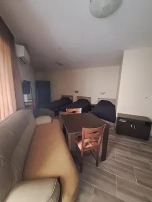 a living room with a couch and a table at LaRaMi Studio in Sveti Vlas