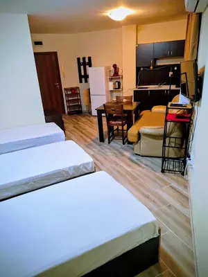 a room with two beds and a living room at LaRaMi Studio in Sveti Vlas