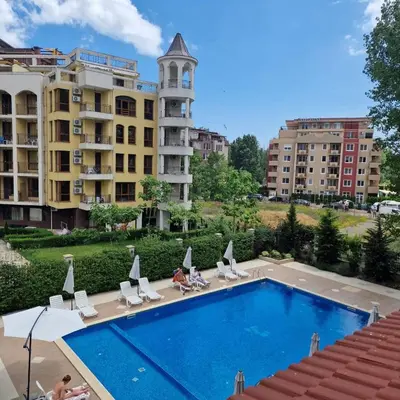 a swimming pool in front of some buildings at U Dacha - Premium Apartments in Sunny Beach