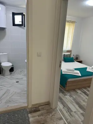 a bedroom with a bed and a bathroom with a toilet at Villa Sea House 2 in Byala