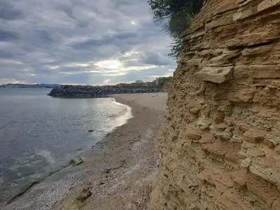 a rocky shoreline with a sandy beach next to the water at MitProt Panorama Bay 2 Luks Studio in Sveti Vlas