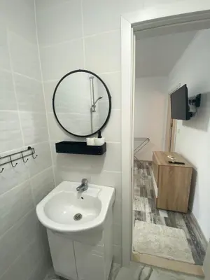 a white bathroom with a sink and a mirror at Villa Sea House 3 in Byala