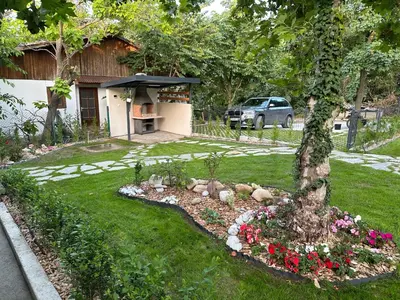 a backyard with a garden with flowers and a house at Villa Sea House 3 in Byala