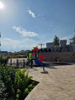 a playground with a slide and an umbrella at Premium 2 bedroom flat at Millennium 2 in Sveti Vlas