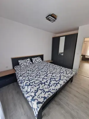 a bedroom with a bed with a blue and white comforter at Premium 2 bedroom flat at Millennium 2 in Sveti Vlas