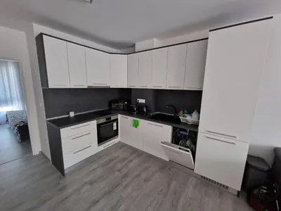 a kitchen with white cabinets and black counter tops at Premium 2 bedroom flat at Millennium 2 in Sveti Vlas