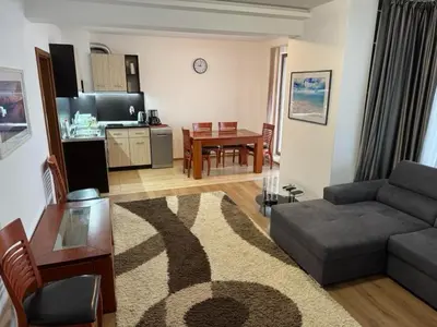 a living room with a couch and a table at Panoramic Sea View Apartment in Byala