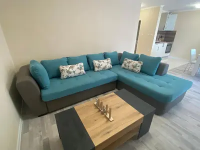 a blue couch in a living room with a coffee table at MARINA BAY 23 Sveti Vlas Beach in Sveti Vlas