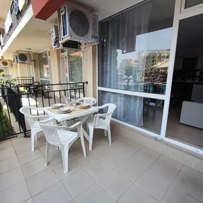 a white table and chairs on a balcony at Sunset Beach 3 - Apartments in Sunny Beach