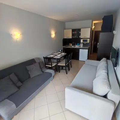 a living room with a couch and a table at Sunset Beach 3 - Apartments in Sunny Beach