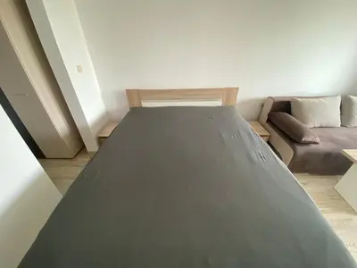 a large bed in a room with a couch at PARADISO 'В' 402 Private Apartment Nessebar in Nesebar
