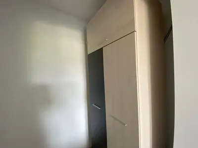 a closet with a wooden door in a room at PARADISO 'В' 402 Private Apartment Nessebar in Nesebar