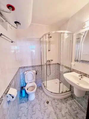 a bathroom with a shower and a toilet and a sink at Cozy Mood Two-bed flat in Sunny Beach in Sunny Beach