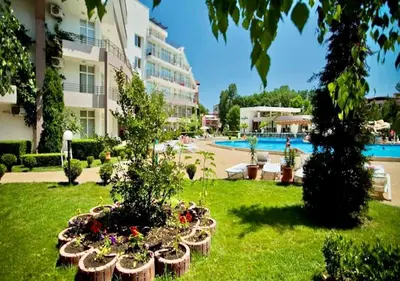 a hotel yard with plants and a swimming pool at Cozy Mood Two-bed flat in Sunny Beach in Sunny Beach