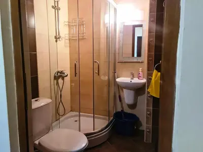 a bathroom with a shower and a toilet and a sink at апартамент под наем на първа линия море in Sozopol