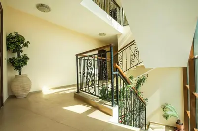 a hallway with stairs and a vase with plants at апартамент под наем на първа линия море in Sozopol