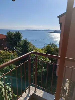 a balcony with a view of the water at Farlalievi Guest House in Sozopol