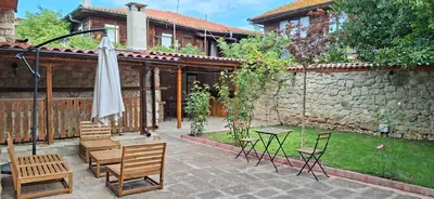 a patio with a table and chairs and an umbrella at Villa Nikoli in Nesebar