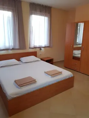 a bedroom with a bed with two towels on it at Villa Nikoli in Nesebar