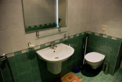 a bathroom with a sink and a toilet at Coral Beach Apartment in Sveti Vlas