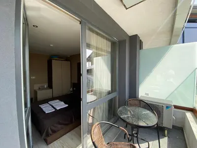 a room with a balcony with a table and chairs at PARADISO 'В' 609 Studio Nessebar Private in Nesebar
