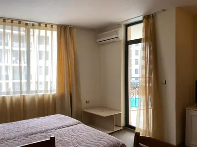 a bedroom with a bed and a large window at AVALON D202 Private Studio Sunny Beach in Sunny Beach