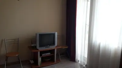a television sitting on a table next to a window at Victoria Perla Apartment in Sunny Beach