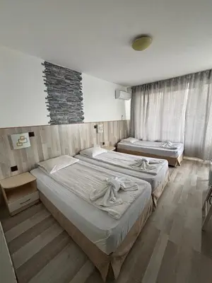 a hotel room with two beds in a room at Свети Никола in Sozopol