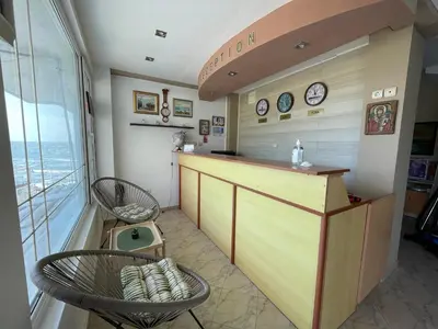 a kitchen with two chairs and a counter with clocks at Свети Никола in Sozopol