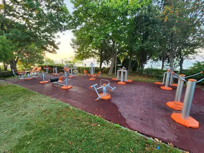 a playground with exercise equipment on a brick ground at VALENCIA GARDENS STUDIO LUX 4 per. in Nesebar