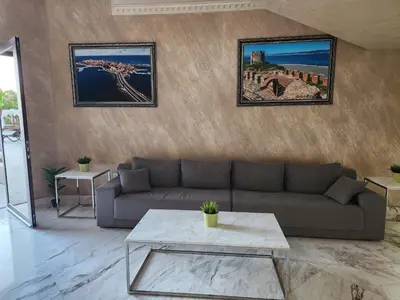 a living room with a couch and a table at VALENCIA GARDENS STUDIO LUX 4 per. in Nesebar