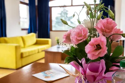 a vase filled with pink flowers on a table at Complex Sunrise by HMG - All Inclusive in Sunny Beach