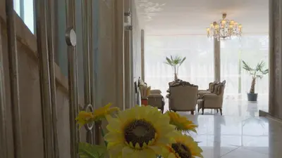 a living room with a vase of flowers on the floor at St. Sofia Beach Hotel in Kiten