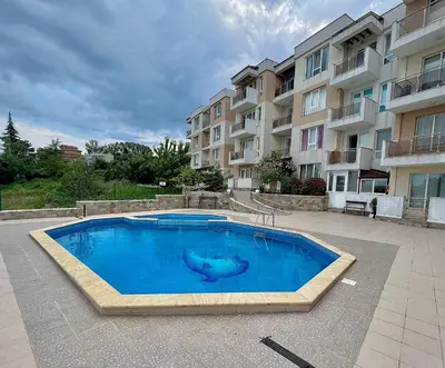 a large blue swimming pool in front of a building at SOLITA Apartment with Panoramic View in Byala