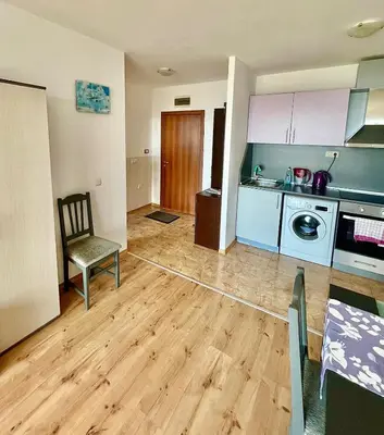 a kitchen with a table and a chair in a room at SOLITA Apartment with Panoramic View in Byala