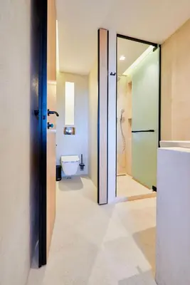 a bathroom with a toilet and a glass door at Hotel Fara - Marina Cape in Aheloy