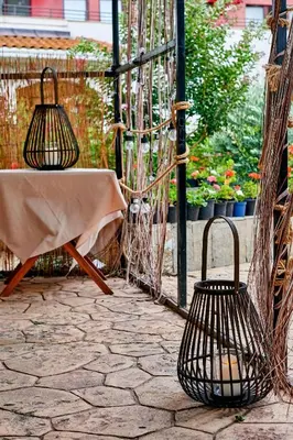 a patio with a table and chairs and flowers at Hotel Fara - Marina Cape in Aheloy