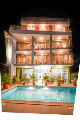 a hotel with a swimming pool in front of a building at Family Hotel Eliri in Nesebar
