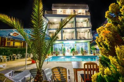 a hotel with a swimming pool in front of a building at Family Hotel Eliri in Nesebar