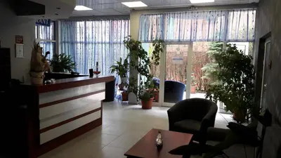 a waiting room with potted plants and a lobby at Family Hotel Eliri in Nesebar