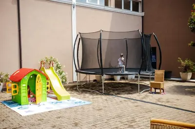 a child is standing on a trampoline at K&E studios and apartments - All inclusive - Free parking in Sunny Beach