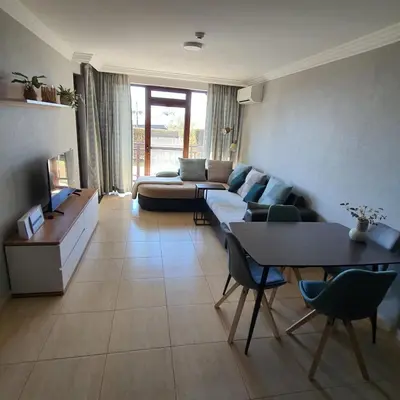 a living room with a couch and a table at Apartment Marina Dinevi View in Sveti Vlas