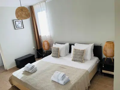a bedroom with a bed with two towels on it at Апартамент Бриз 16 in Sunny Beach