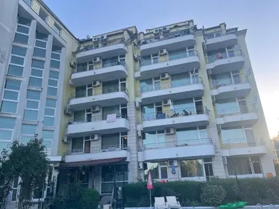 an apartment building with balconies on the side of it at Апартамент Бриз 16 in Sunny Beach