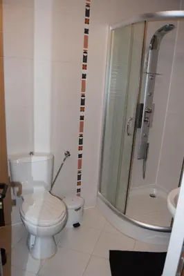 a bathroom with a shower and a toilet and a sink at Paradise Bay Villas in Sozopol