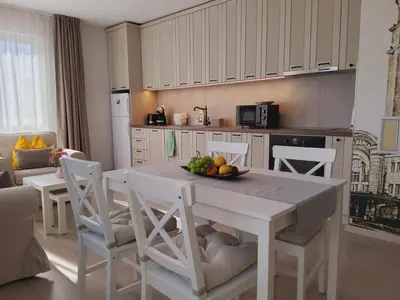 a kitchen with a table with a bowl of fruit on it at апартамент Релакс in Varna City