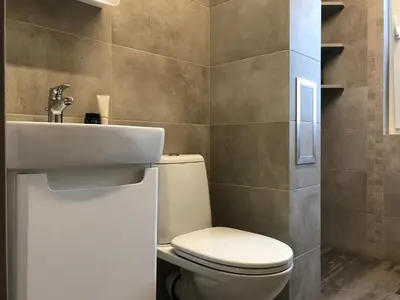 a bathroom with a toilet and a sink at апартамент Релакс in Varna City