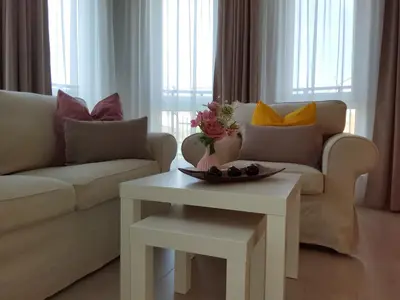 a living room with a couch and a table at апартамент Релакс in Varna City